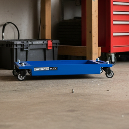 Workshop with tools on a pegboard, a red toolbox, and a blue cart.