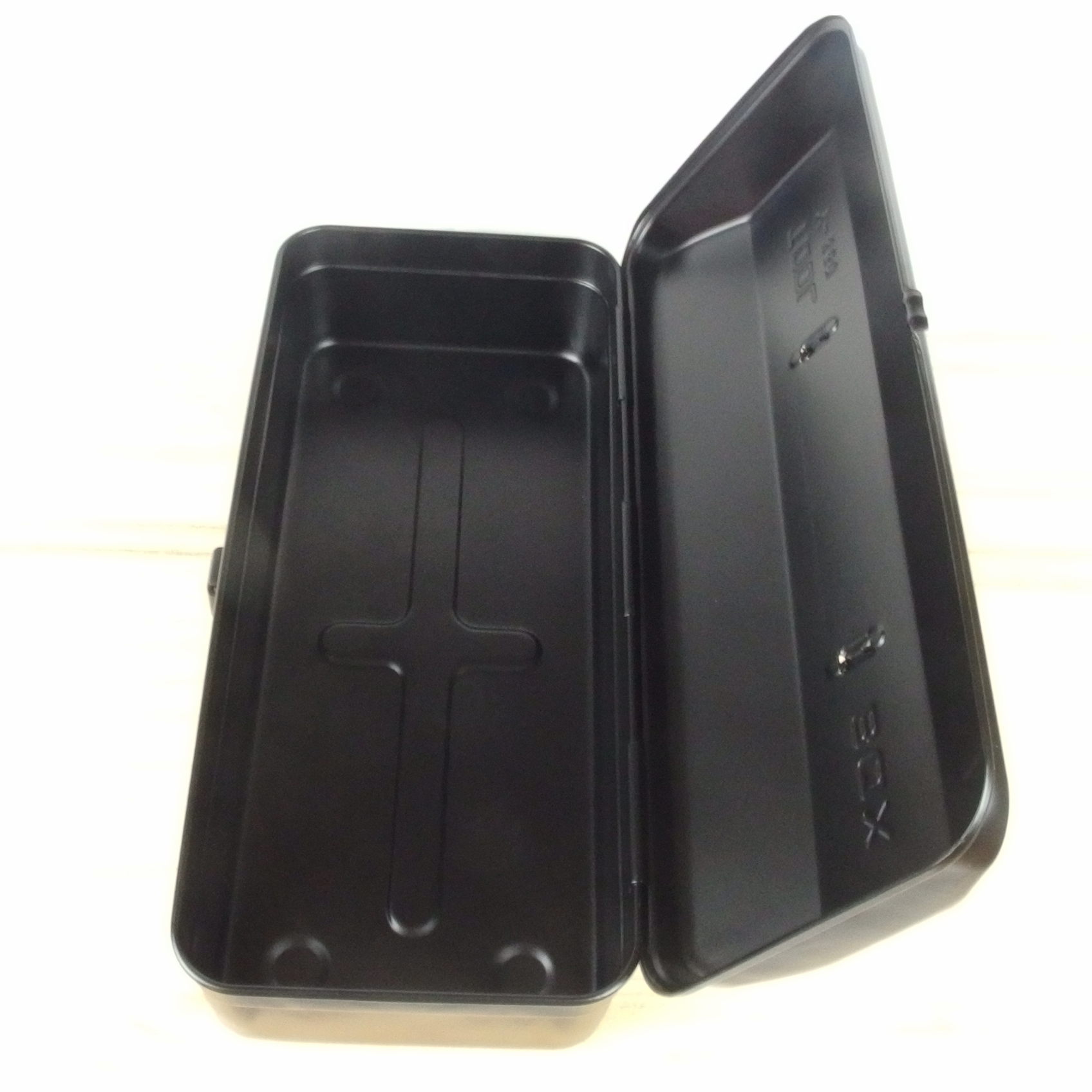 Black steel tool box with a cross design on a white background