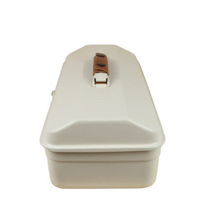 White storage box with a brown handle on a wooden surface